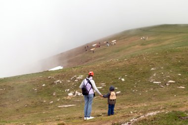 Anne ve çocuk dağın tepesinde.