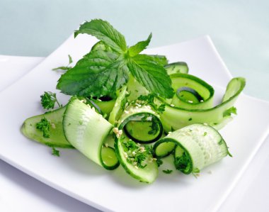 Cucumber salad with greens and sesame clipart