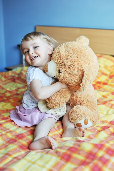 Little girl with soft toy — Stock Photo, Image