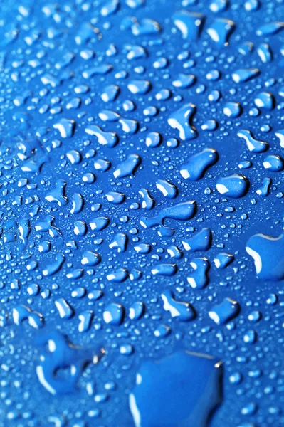 Water drops on color background — Stock Photo, Image