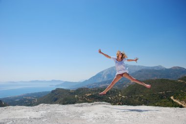 Girl on mountaion jumping clipart