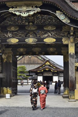 Women in kimono enters to Nijo castle clipart