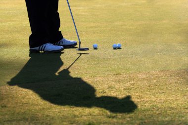 Golfer Practices His Putt clipart