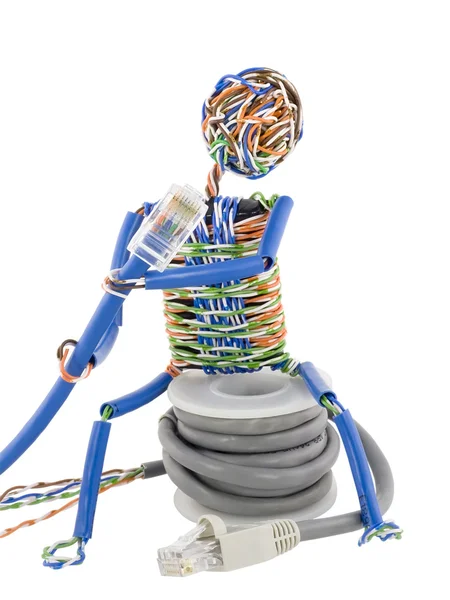 Twisted man looks on patch cable — Stock Photo, Image