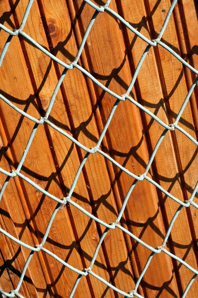Wooden panels behind a lattice — Stock Photo, Image
