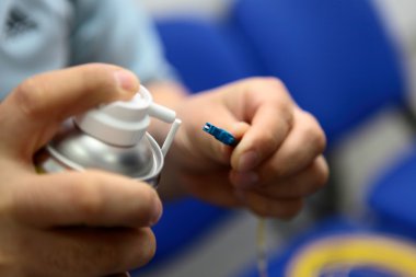 Engineer cleaning of an optical fiber clipart