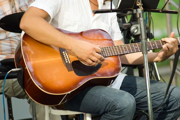 stock image Man is playing on acoustic guitar