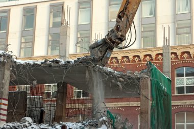 Heavy dredger demolishes building clipart