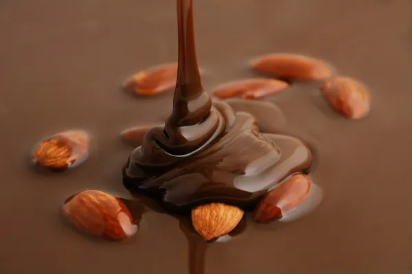 Liquid chocolate with nuts — Stock Photo, Image