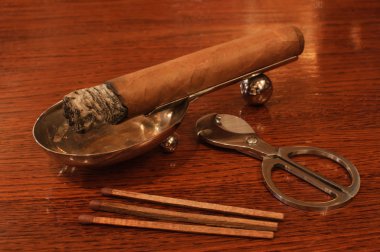 Cigar on a stand matches&cutters clipart