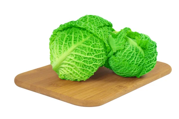 Savoy cabbage on a wooden board — Stock Photo, Image