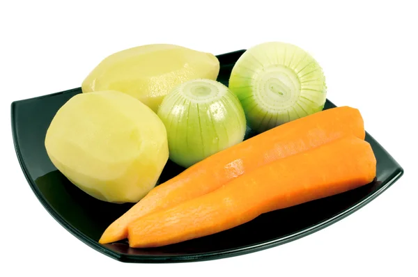 Légumes pelés dans une assiette — Photo