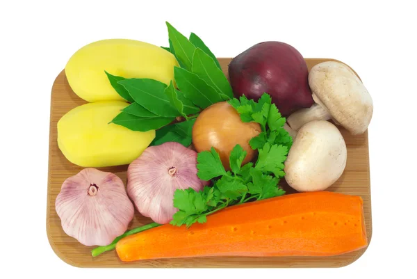 Board with potatoes, garlic, carrots — Stock Photo, Image