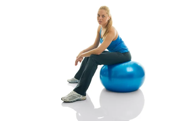 Genç kadın fitness topu üzerinde oturan — Stok fotoğraf