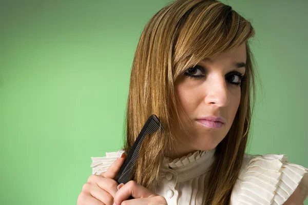 stock image Young women combing her hair