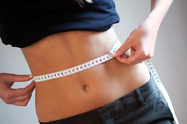 Women measuring waist — Stock Photo, Image