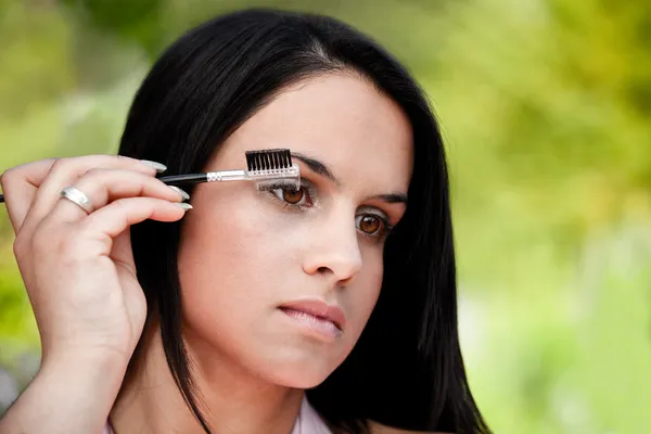 Beautiful women combing eye brows — Stock Photo, Image