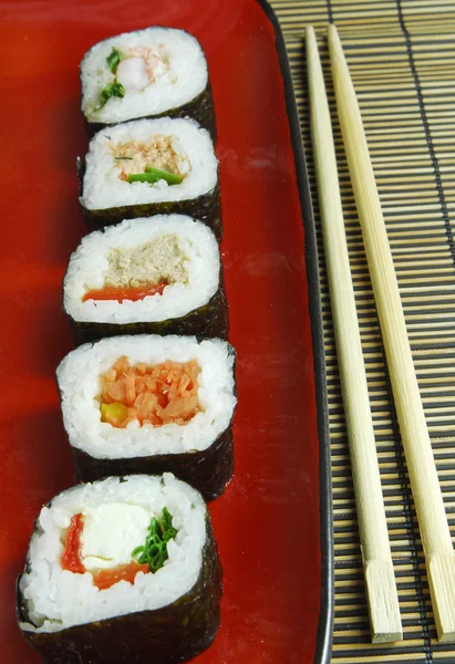 Sushi futomaki with chopsticks — Stock Photo, Image