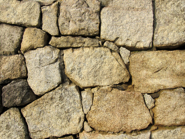 Stone wall textured background in light brown color