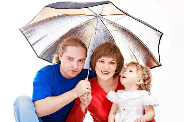 Happy family under umbrella — Stockfoto