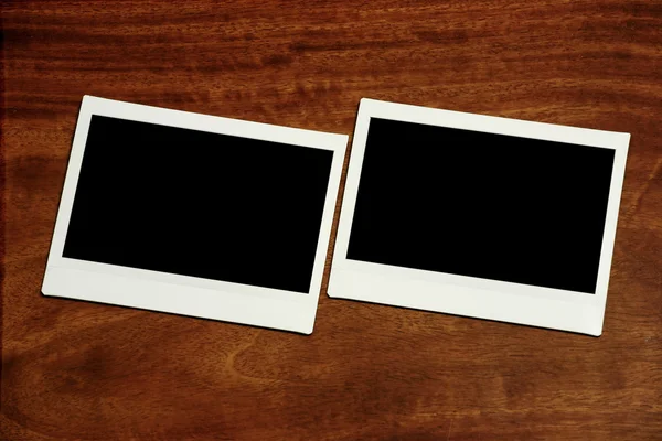 Two empty polaroids on wooden background — Stock Photo, Image