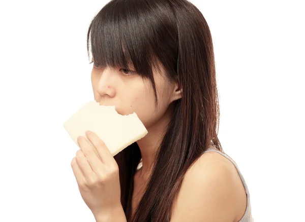 Chinese girl look sad and eat bread — Stock Photo, Image