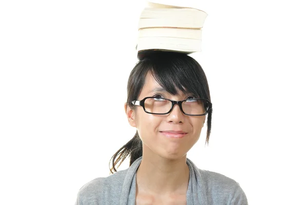 Girl with books on head — Stock Photo, Image