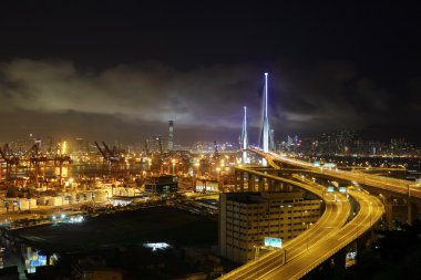 Container terminal and bridge in Hong Kong at night clipart