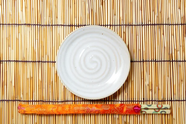 Plate and chopsticks — Stock Photo, Image