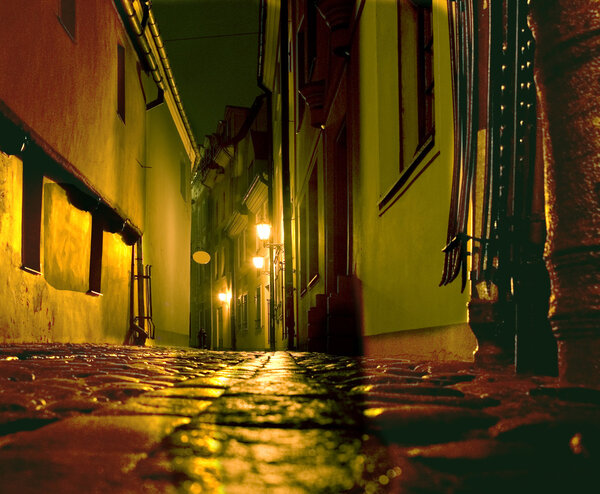 Ancient narrow street in old city in Riga at night