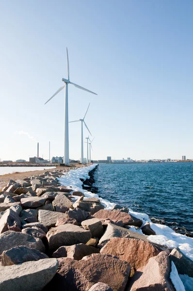 Windmills near seaside covered with big stones — Stock Photo, Image