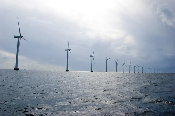 Windmills in a row on cloudy weather — Stock Photo, Image