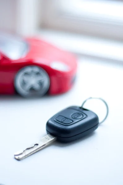 stock image Car key near small remote red super car, vertica