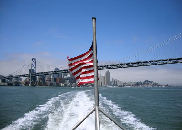 stock image Tattered USA flag waves in the wind on the back of a ferry with