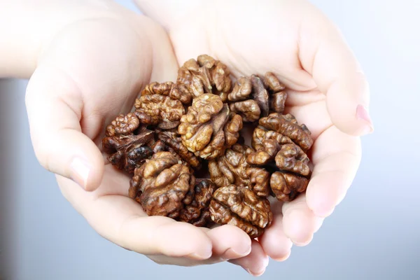 Walnut nuts in hands — Stock Photo, Image