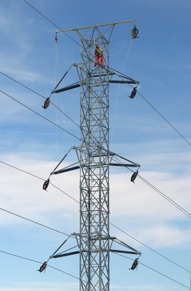 Worker on top of a hydro tower — Stock Photo, Image