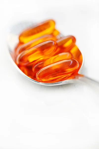 Vitamin Gel Caps on Spoon Stock Photo