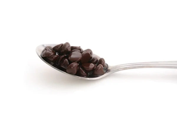 Čokoládové šupinky na lžíci — Stock fotografie