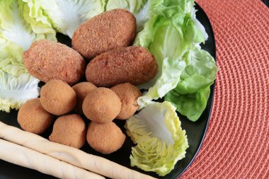 Mixed plate of fried appetizers clipart