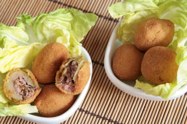 Fried olives in white bowls clipart