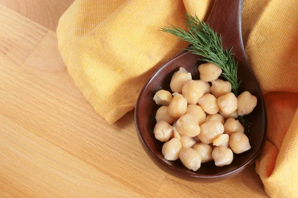 Chickpeas in a wooden spoon — Stock Photo, Image
