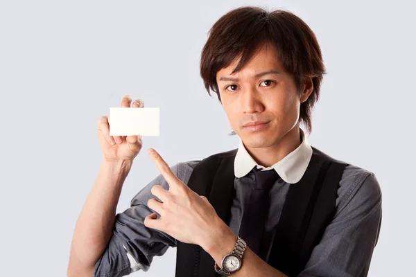 Asian business man pointing at card — Stock Photo, Image