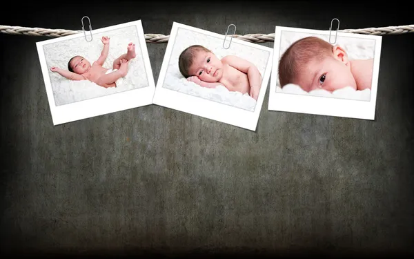 Cute baby photos hanging on rope — Stock Photo, Image