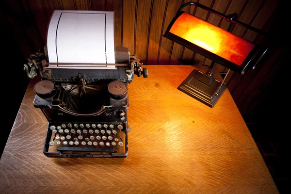 Desk with old typewriter and lamp — Stock Photo, Image