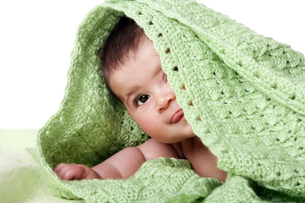 Cute happy baby between green blankets — Stock Photo, Image