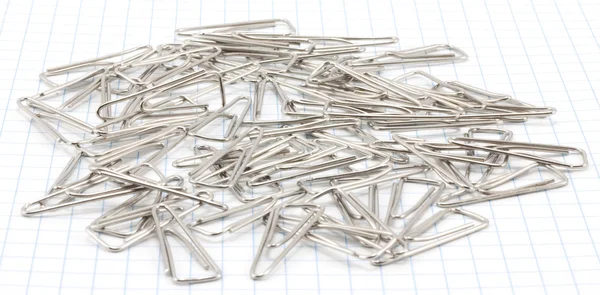 Triangular paper clips on paper — Stock Photo, Image