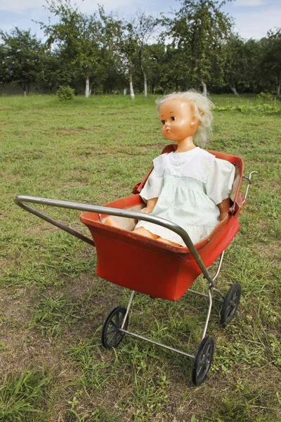 stock image An old doll in the stroller