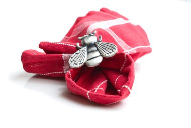 Napkin with a ring in the form of a fly. clipart