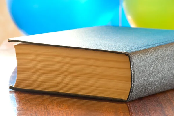 Thick book on a polished table Stock Picture