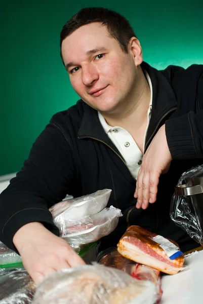 stock image Still-life. The man in food products.